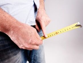 a man measures his penis before enlarging with soda