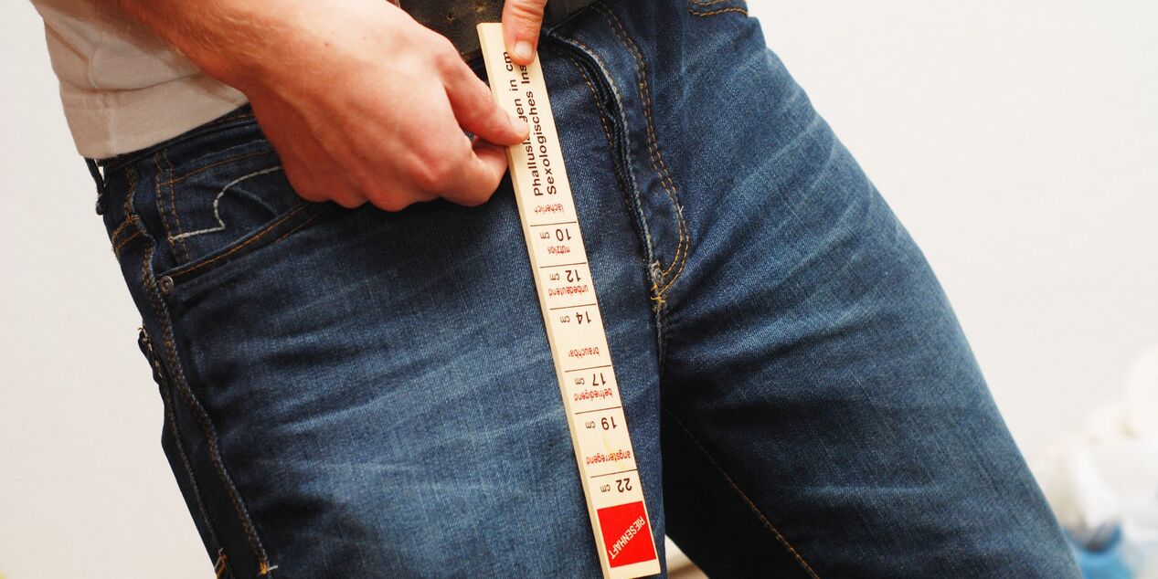 Man measures his member length